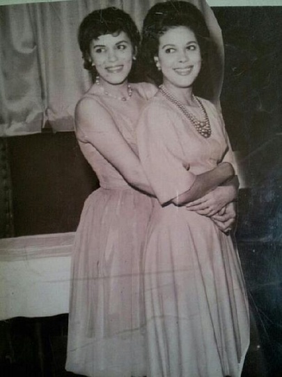 Black and white photograph of Hilda Simms (right) posed with one of her younger sisters, Laura, c.1955.